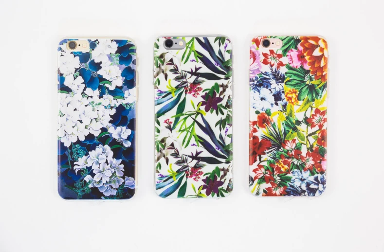 three floral iphone cases, one being colorful