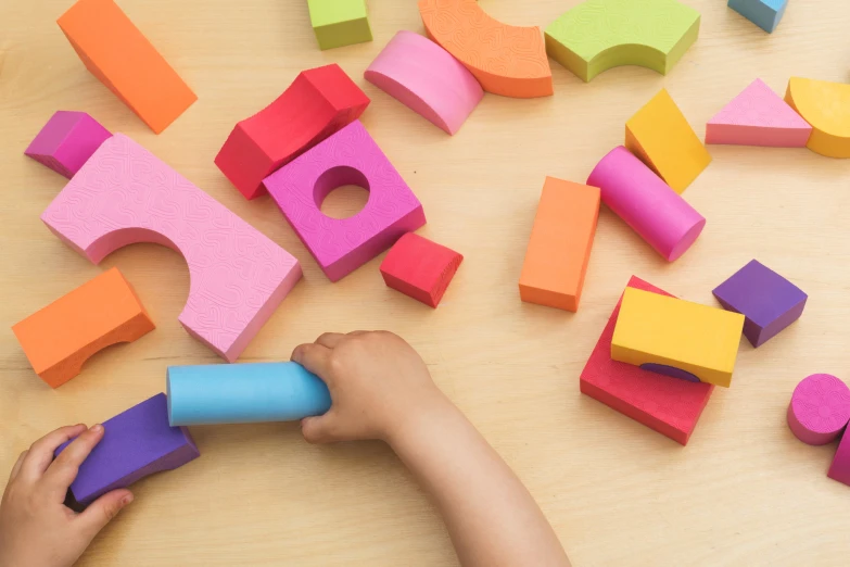 a young child playing with blocks and letters