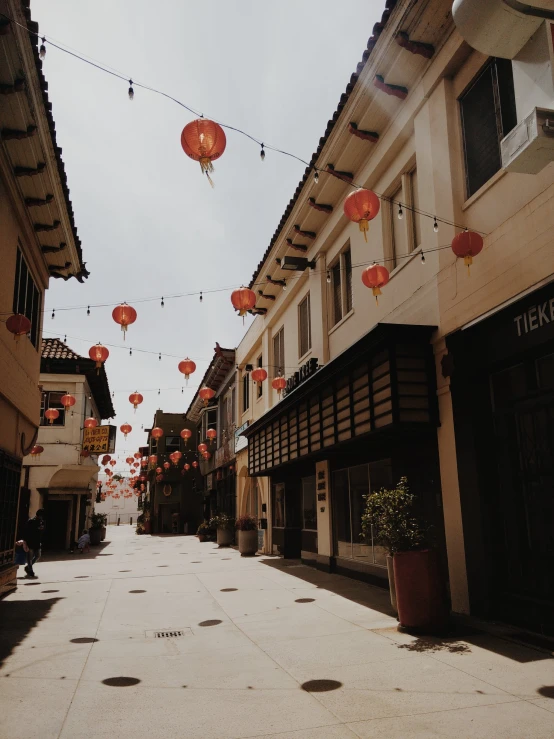 street lined with houses and red lanterns in the middle