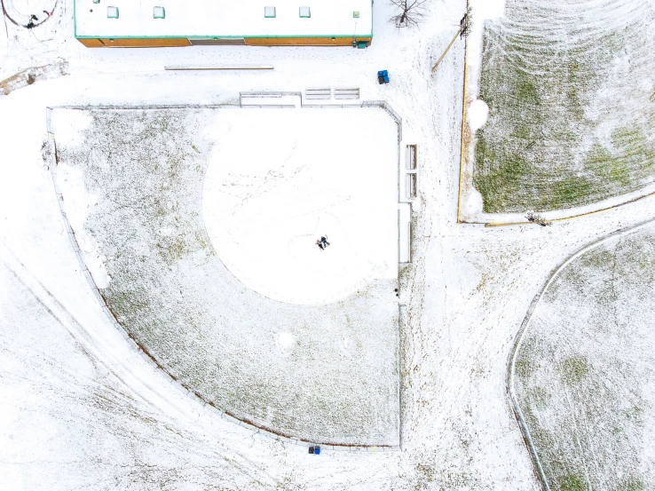 aerial view of baseball field in winter with snow on ground