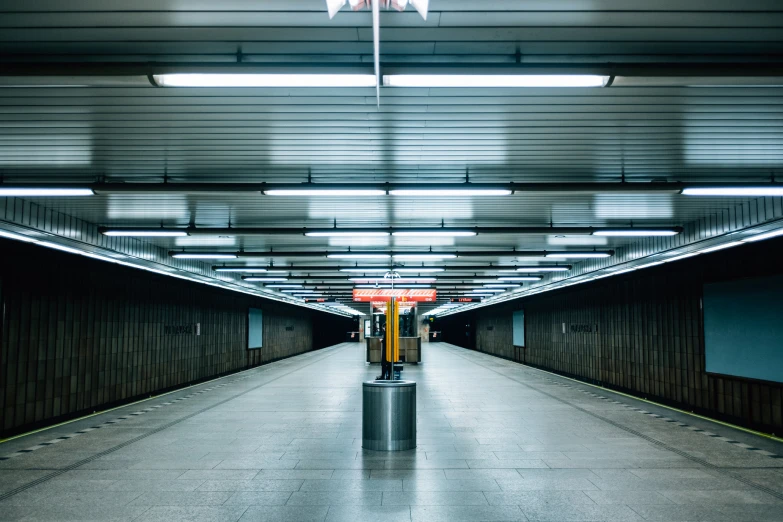 there is a long metal hallway with lights