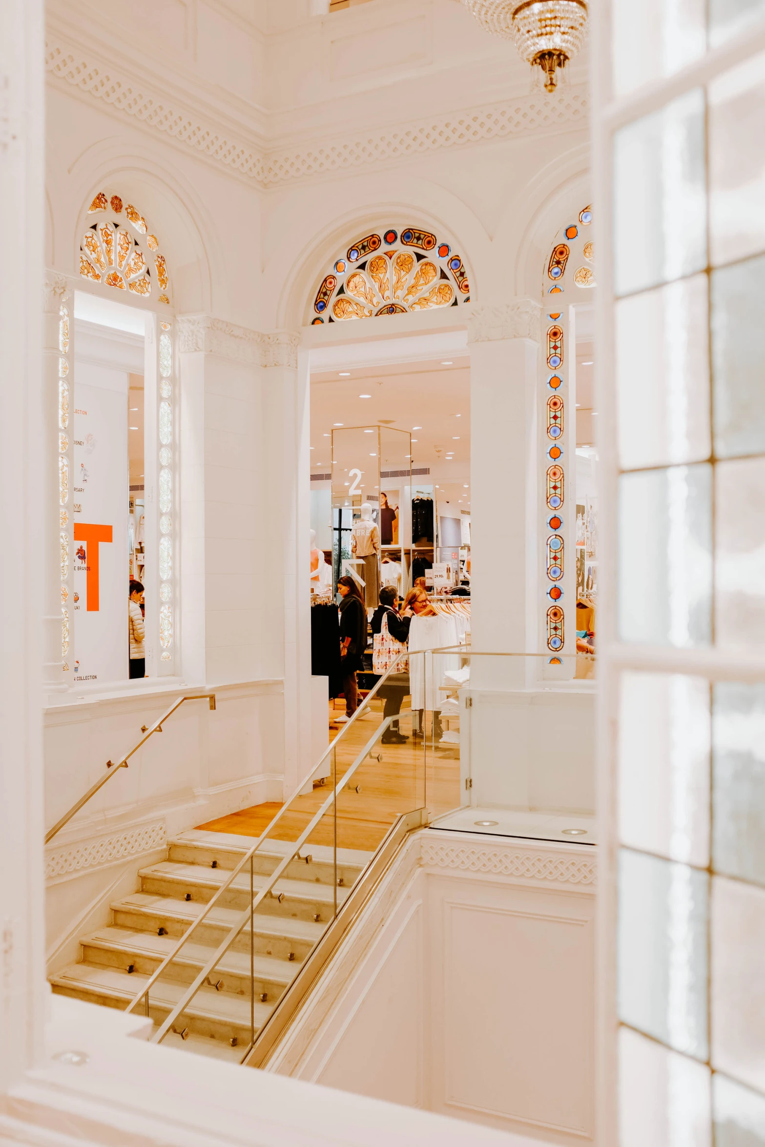 a couple people are standing outside of a fancy building