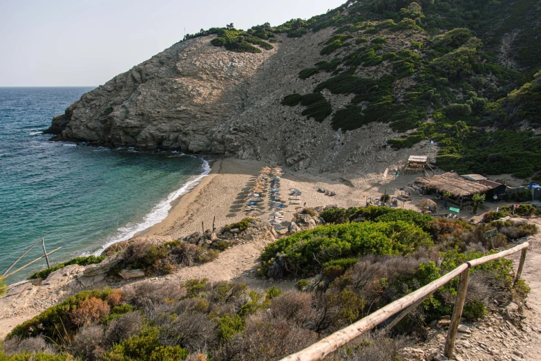 view of a beach and the ocean next to a cliff