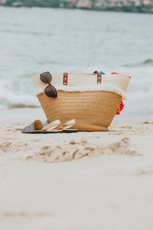 an open bag sitting on top of a sandy beach