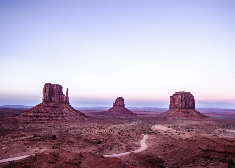 the mountains surrounding the desert have desert like terrain and a path