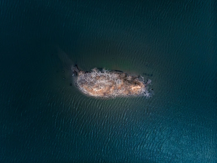 an aerial s of a rock formation in water