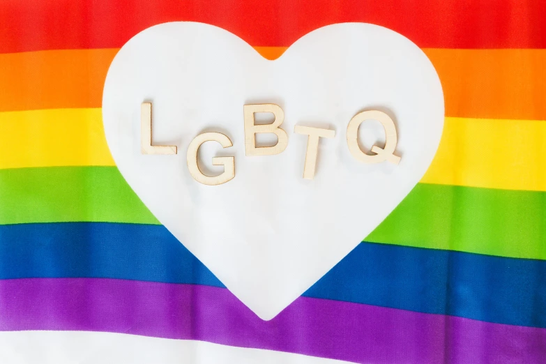 the letters lgbt spelled with wooden letters in a heart