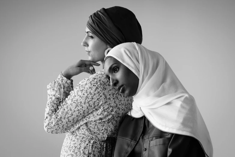 two women wearing headscarves and a hijab