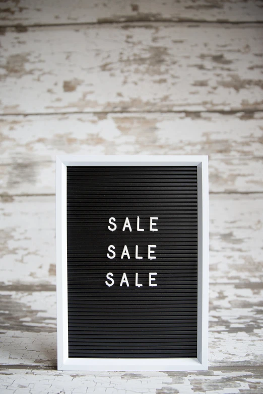 a black sale sign that says sale sale sale in white lettering