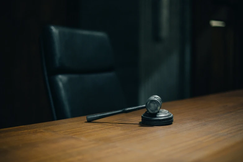 an empty black can phone on top of a wooden table