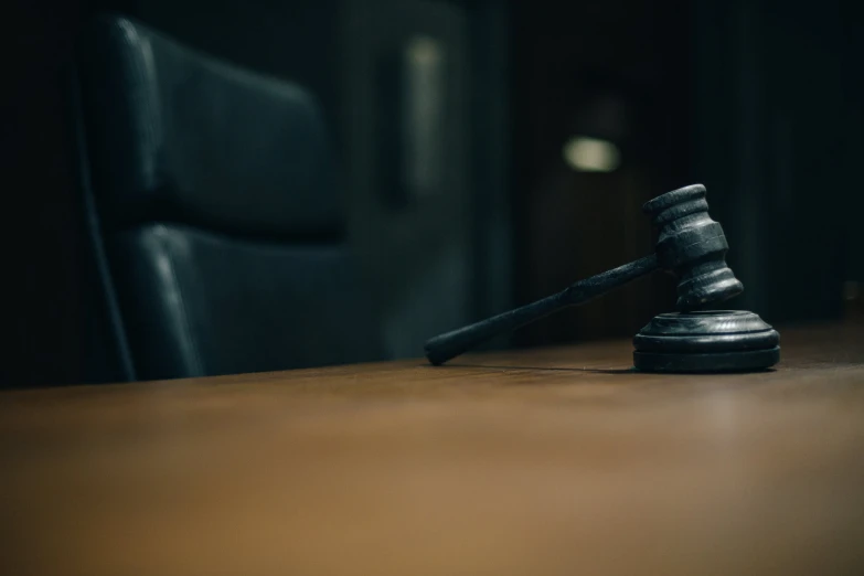 a wooden judge block sits on a desk