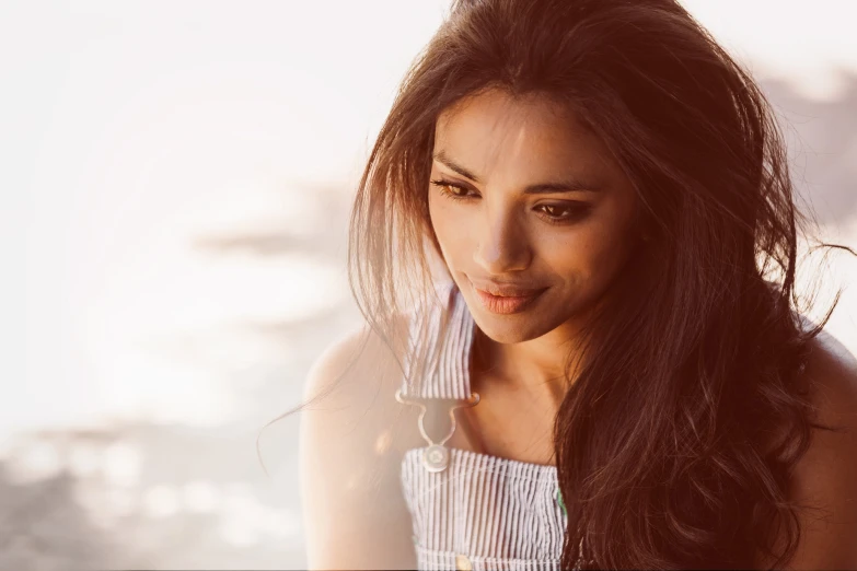 a beautiful young woman posing with long dark hair