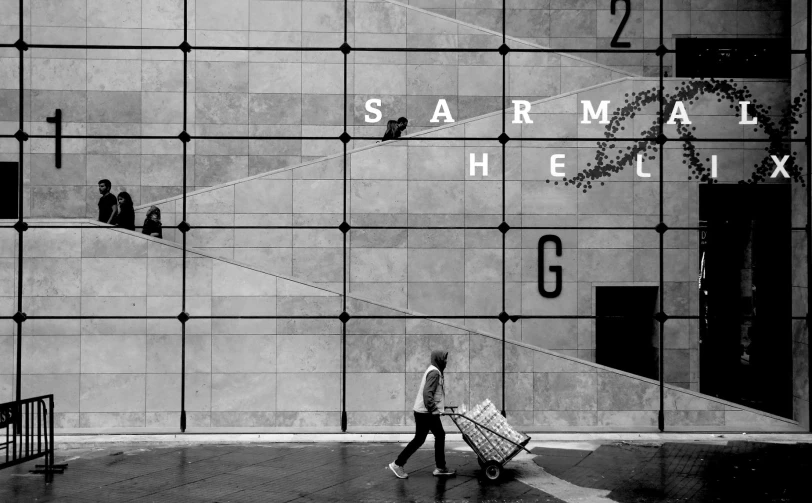 a woman hing a grocery cart through a commercial building