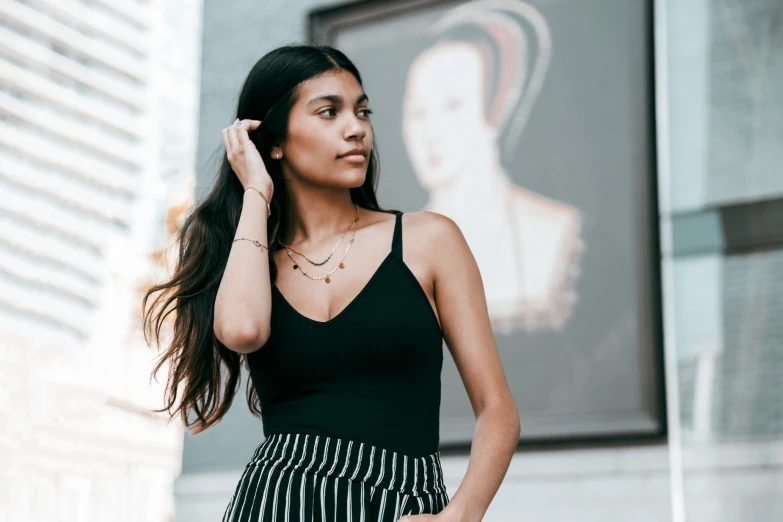 young woman talking on the phone wearing striped skirt