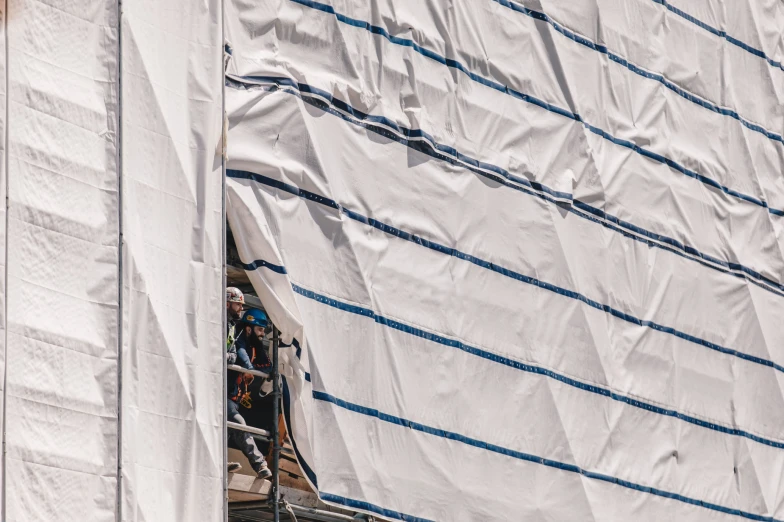 a man is looking out the window of a sail boat