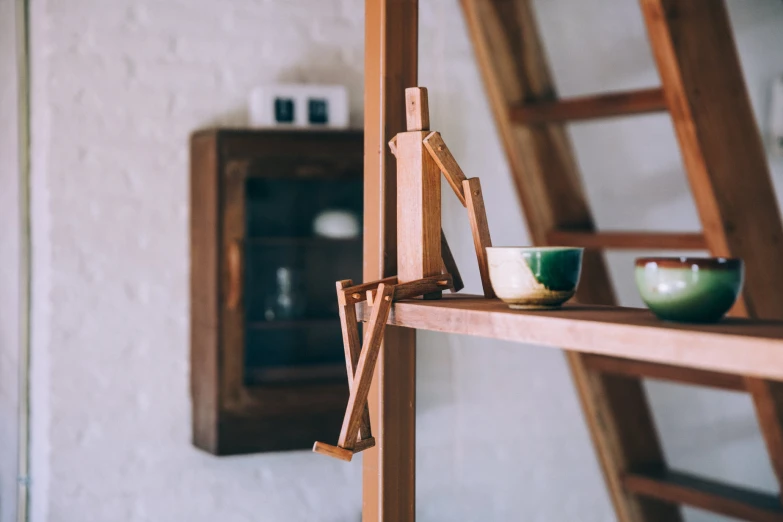 a wooden ladder is leaning up on the side of a wall