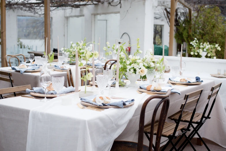 a table set for a fancy dinner with floral centerpieces