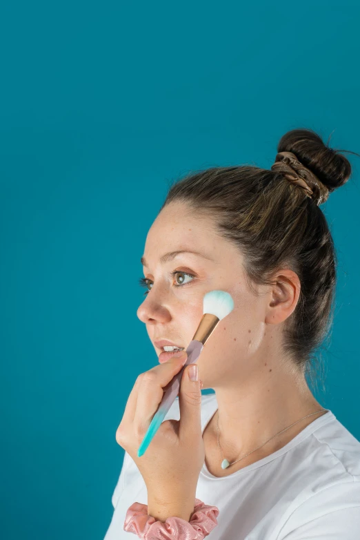 a beautiful woman holding a toothbrush to her face