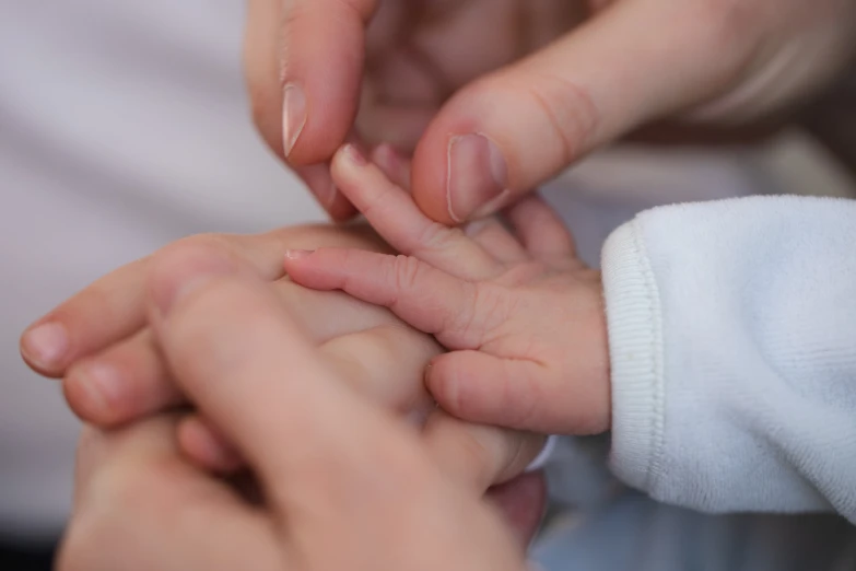 two people are holding hands together with one of them holding another hand