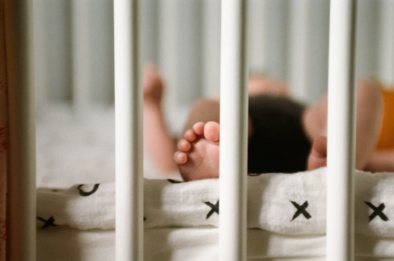 a baby is laying down in a crib