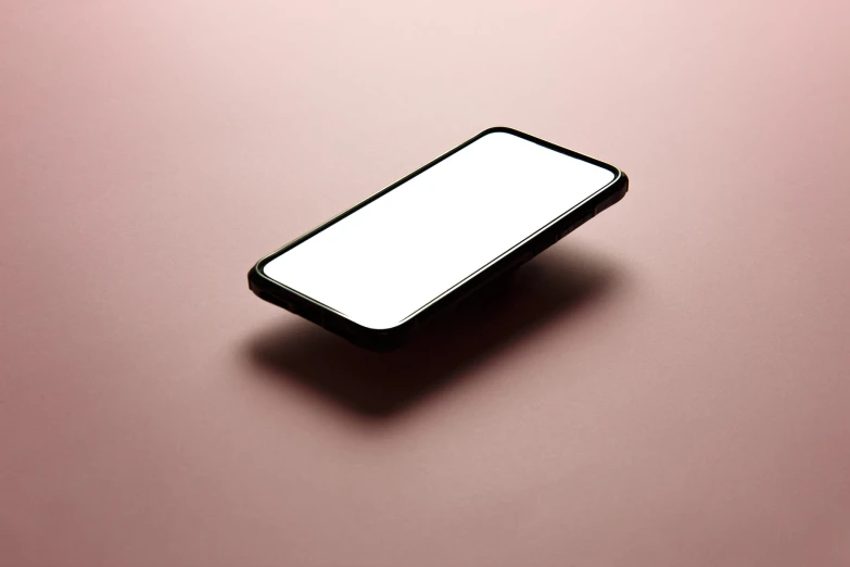 the white case is on the pink surface