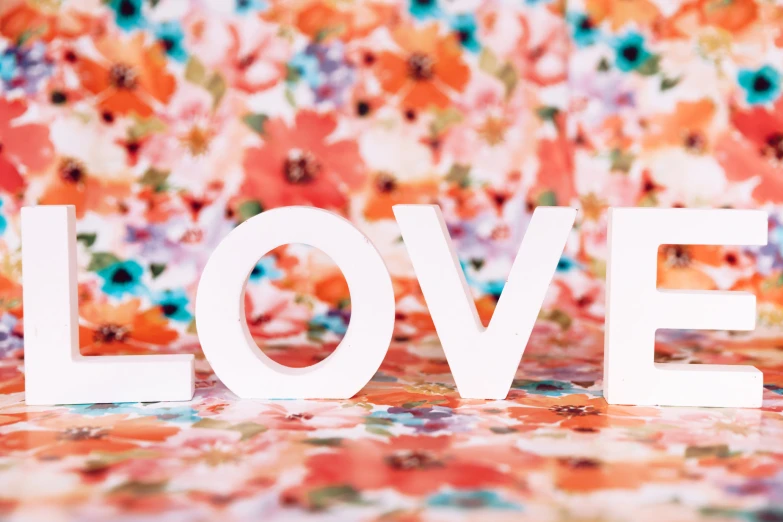 a pograph of an over - sized flowered wallpaper with the words love on top