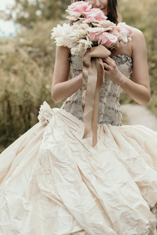 a woman wearing a dress with flower petals tied to it