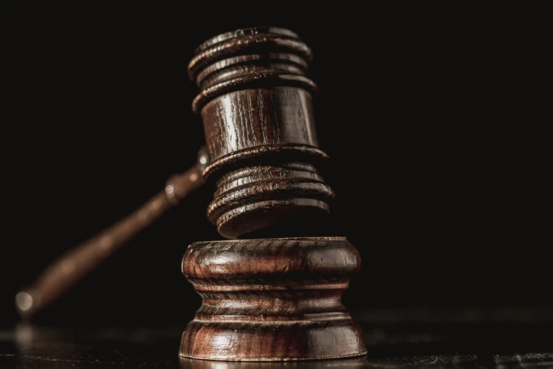 a judge hammer resting atop the top of a judges block