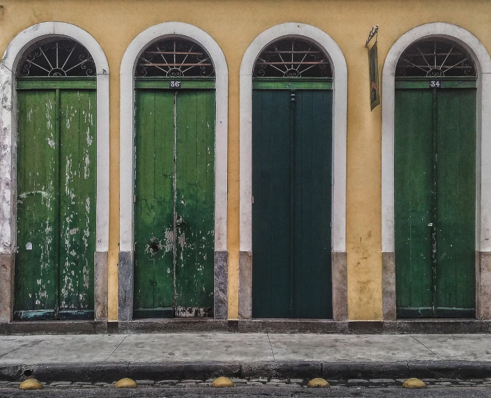 three green door that are on a building