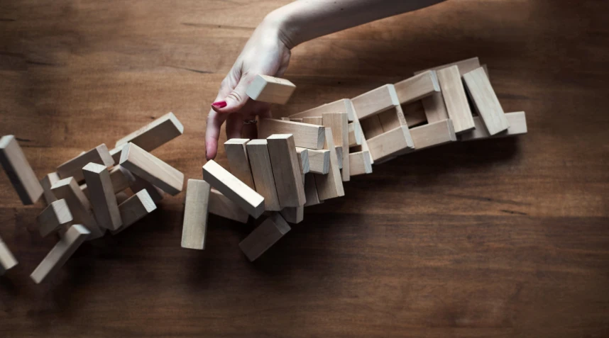 a woman holding the letter e on a piece of wood