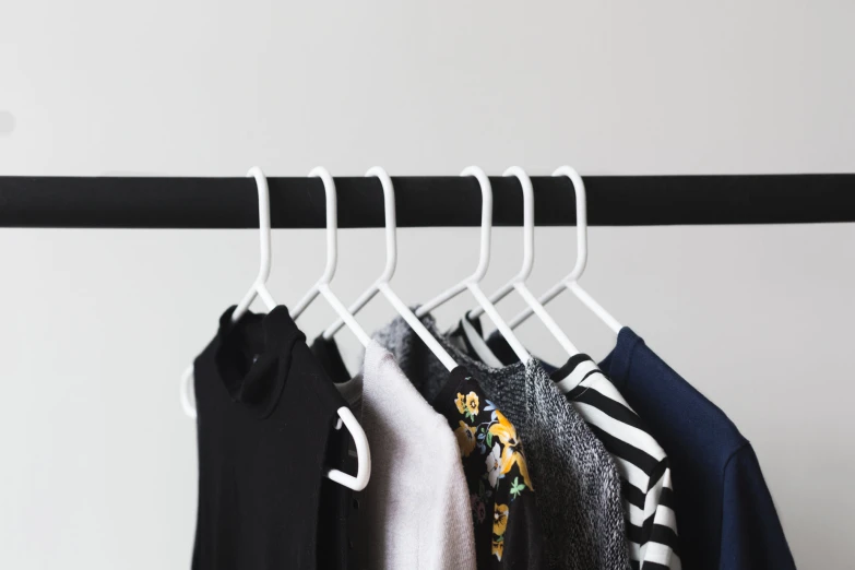 some hangers with clothes hanging on them