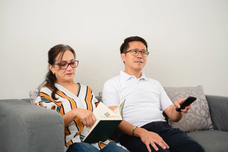 a man and woman are sitting on a couch