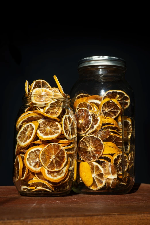 two mason jars filled with sliced oranges