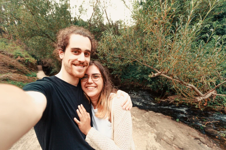 the man and woman are taking pictures with a camera