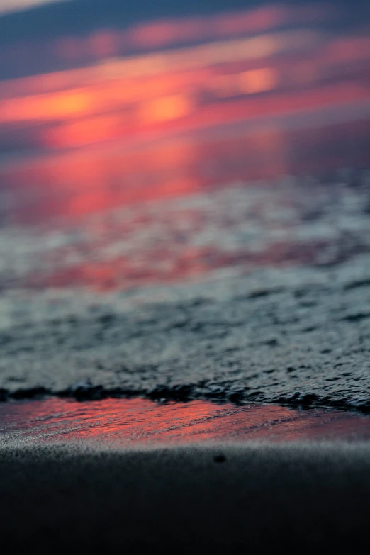 a blurry po of sand, water, and sky