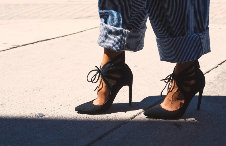 a woman wearing a pair of  black high heeled sandals