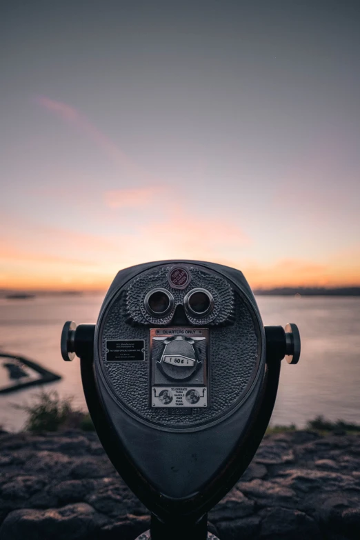 a coin meter is sitting on some rocks