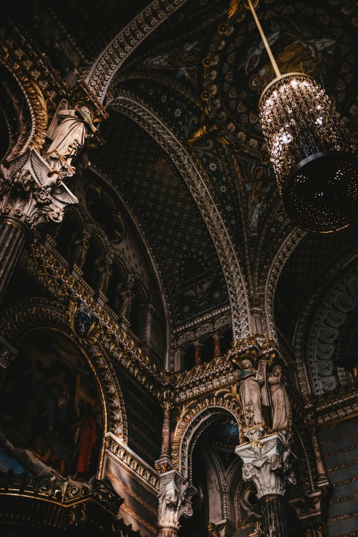 an intricately designed church has a chandelier and paintings