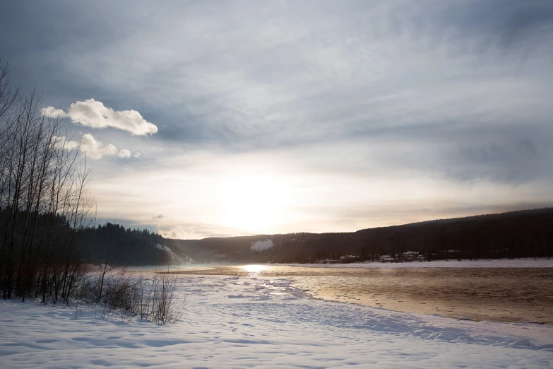 the sun is shining down on a frozen body of water