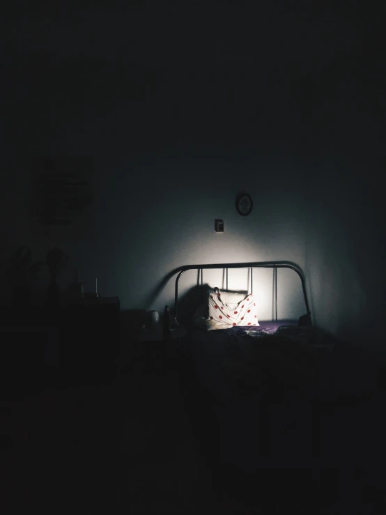 a bed that has a lit up head board in it