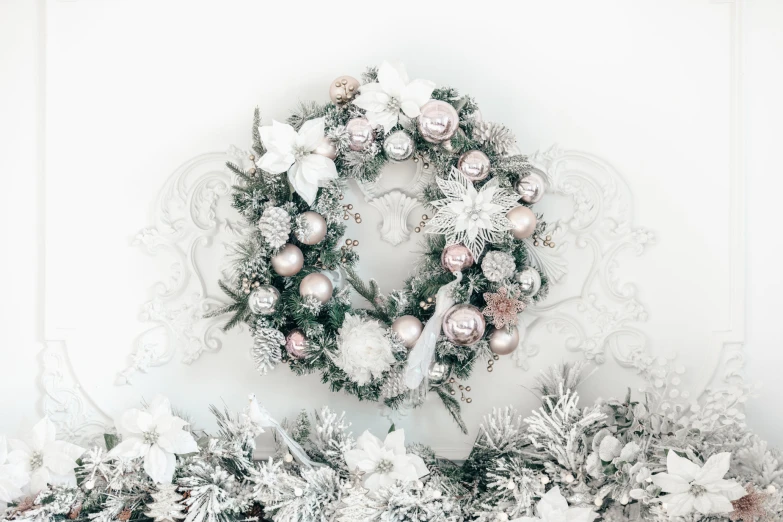 a picture with a white background and a wreath on the wall