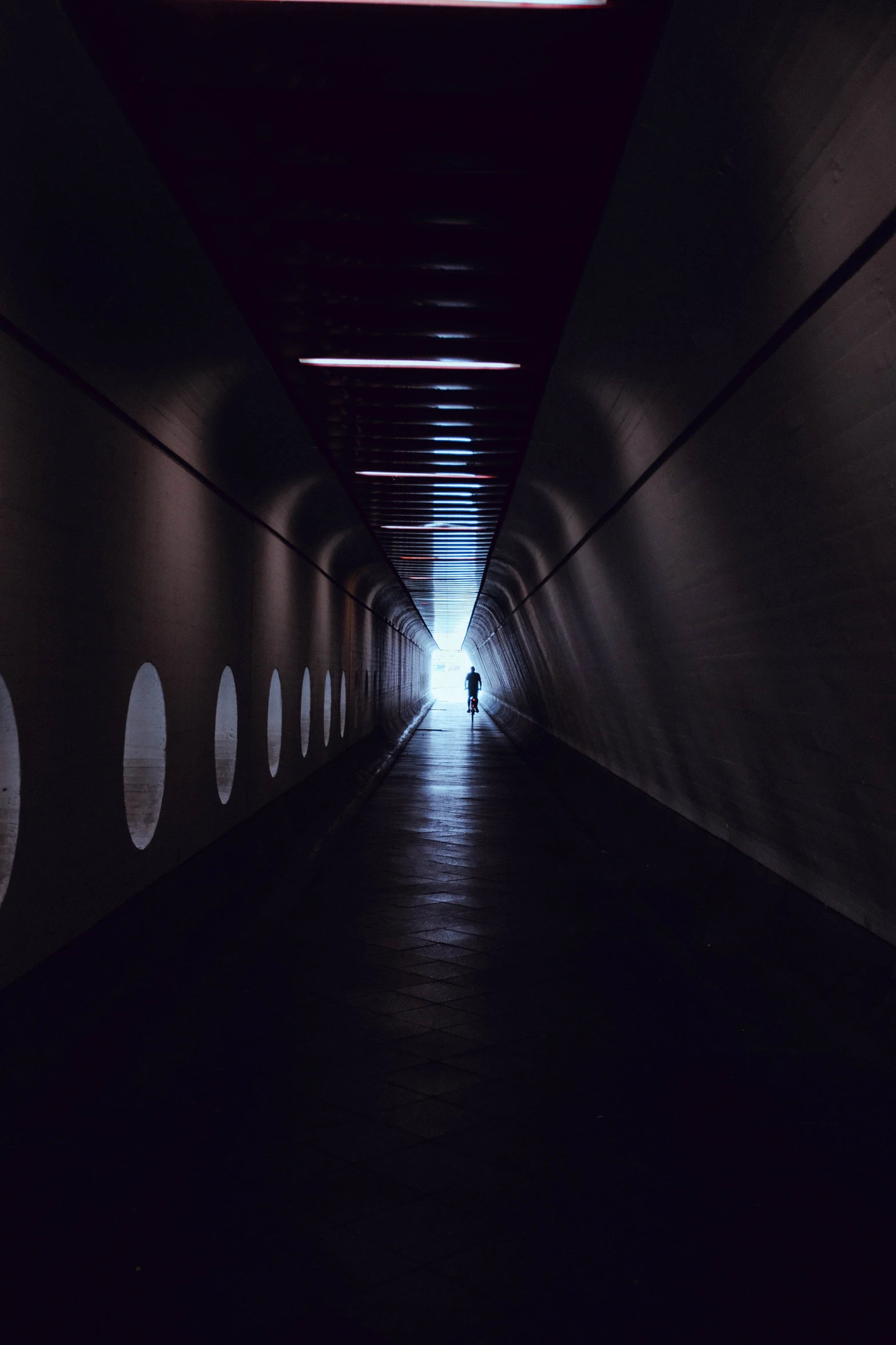 a person walks through the tunnel in the dark