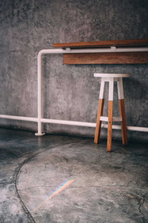 a stool in front of a wall with the top up