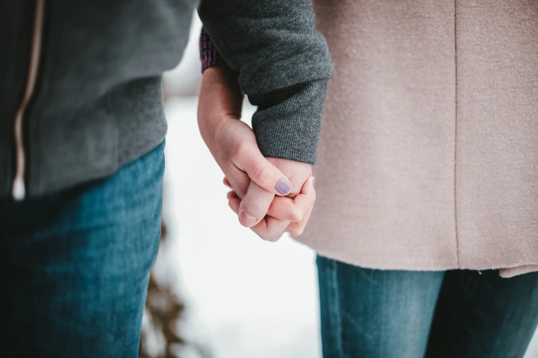 two people are holding hands and posing for a po