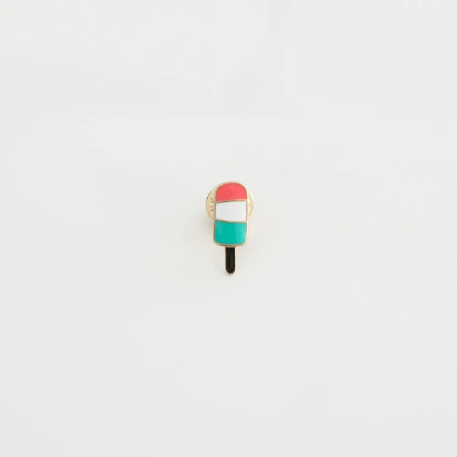 a red, white and green pin sitting on top of a table