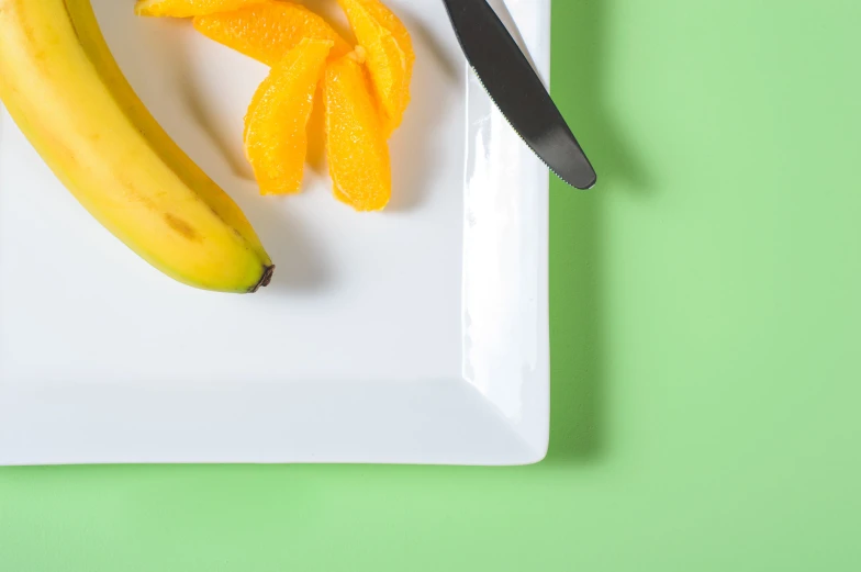 banana and other fruit sitting on a plate