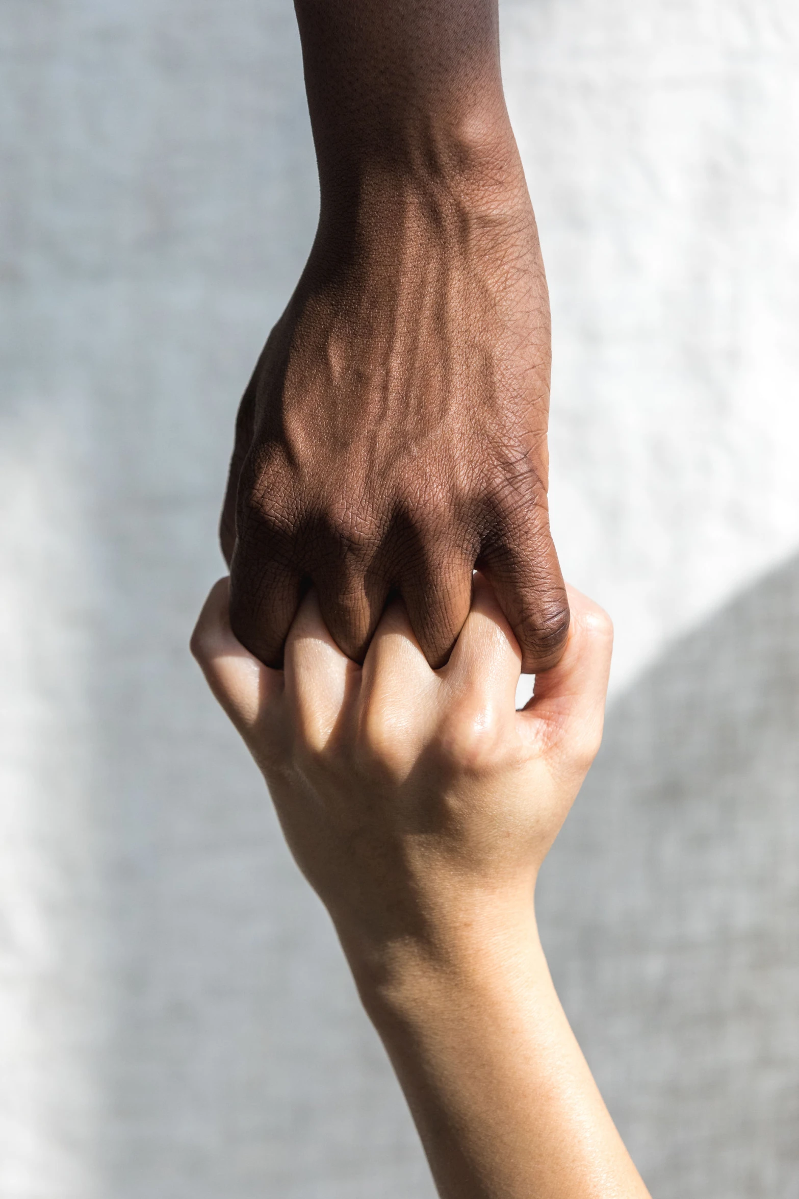 two hands reaching up towards each other and reaching to touch the other