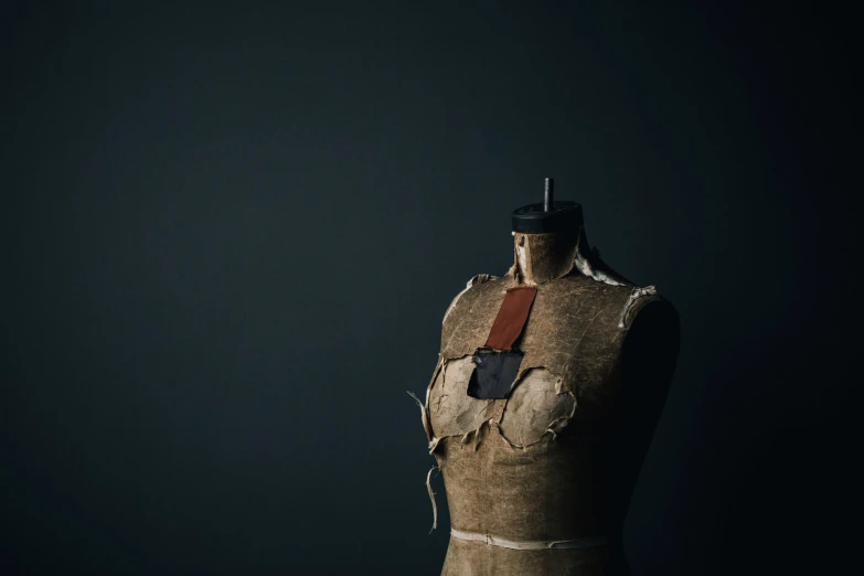 an old piece of clothing with leather straps and a brown leather belt