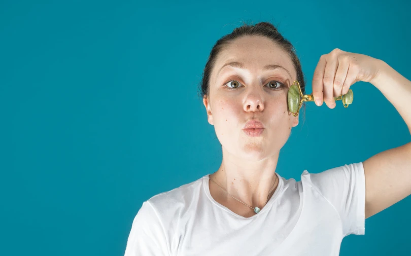 a woman with an item in her hand making a funny face