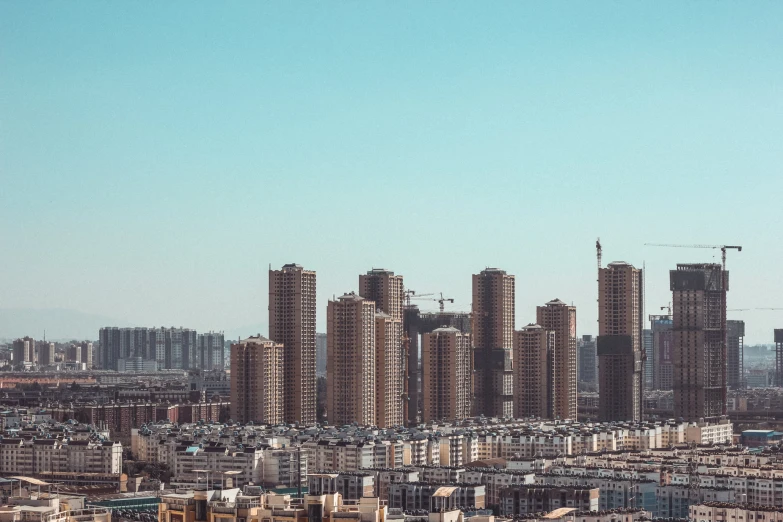 a very large city with tall buildings and blue sky